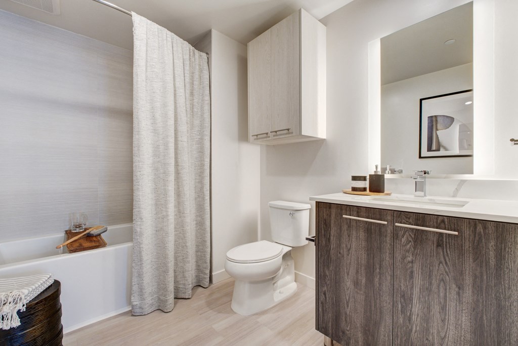 a bathroom with a toilet and a sink and a bath tub