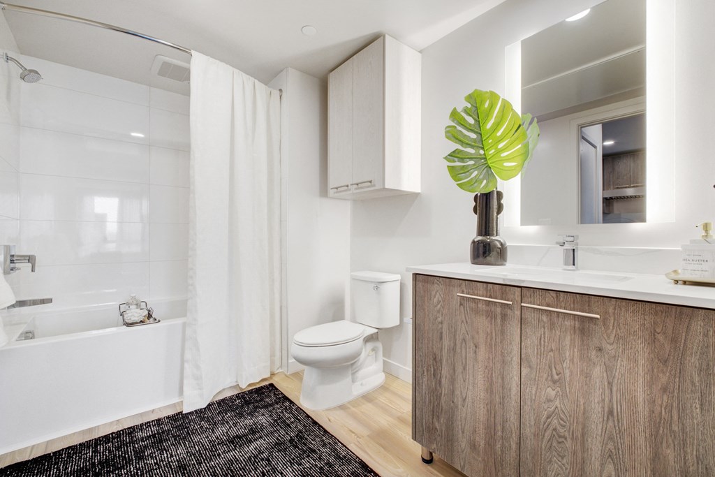 a bathroom with a toilet and a sink and a bath tub