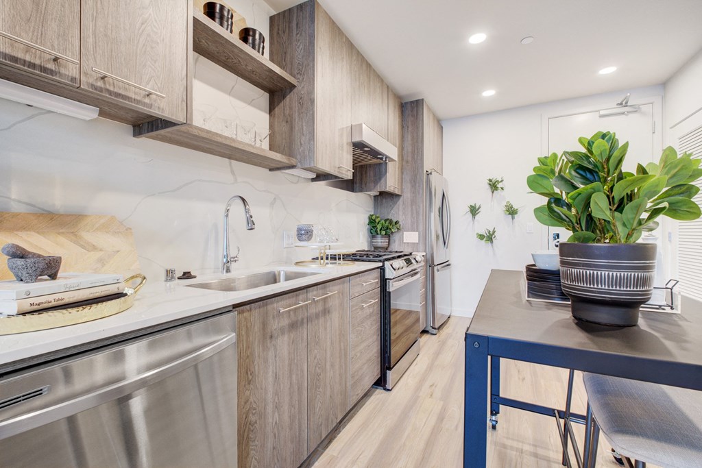 a kitchen with stainless steel appliances and wooden cabinets