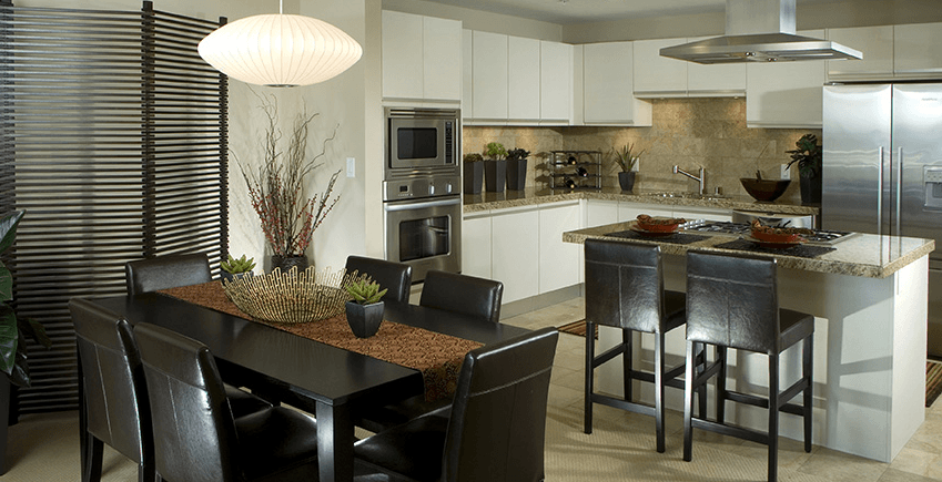 A modern kitchen with a dining table and chairs.