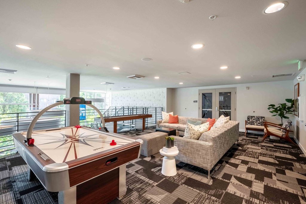 a game room with a pool table and couches at Astro Apartments, Seattle, WA, 98109