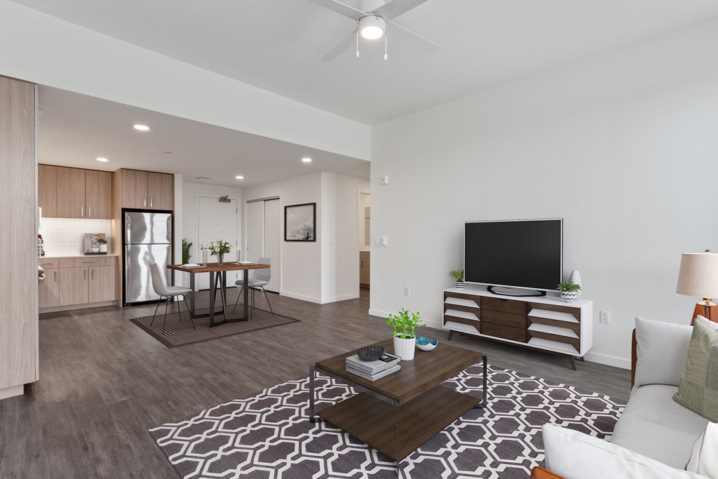 a living room with a couch and a coffee table in front of a flat screen tv