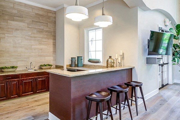 a kitchen with a counter top and three stools