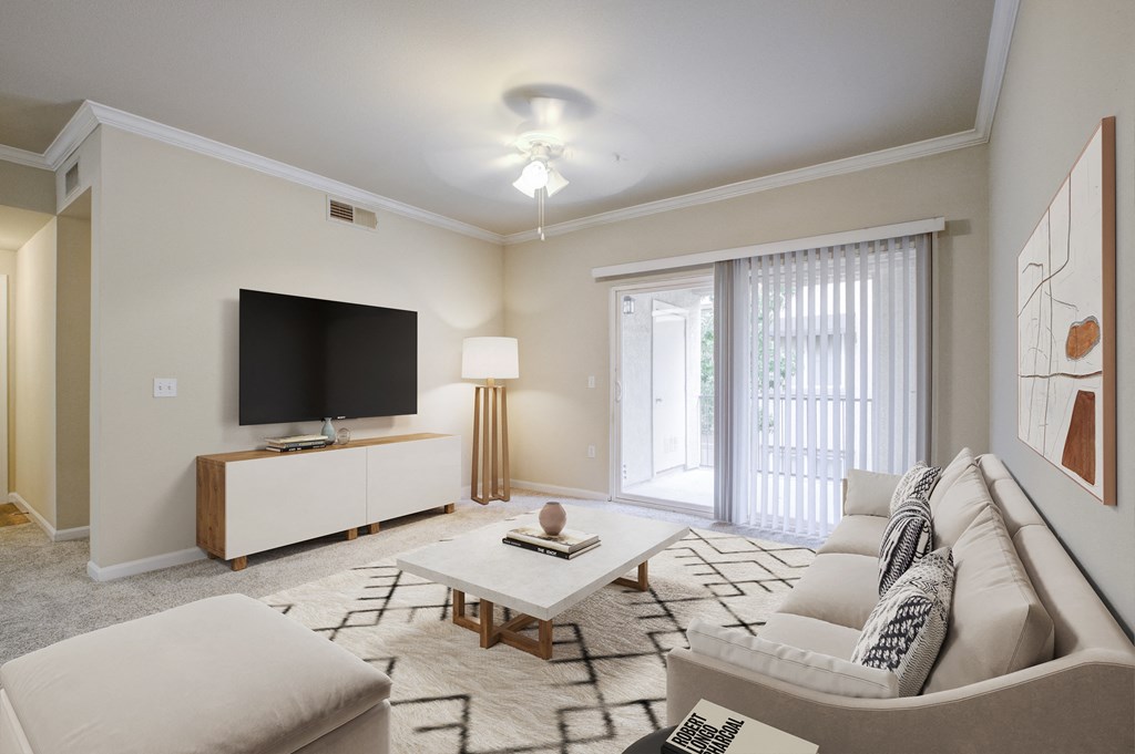 Sacramento, CA, Apartments Near Golden 1 Center - Avanti - Living Room with Plush Carpeting, Couch, Ottoman, Coffee Table, Media Console, TV, Ceiling Fan, and Sliding Glass Door with Access to Patio