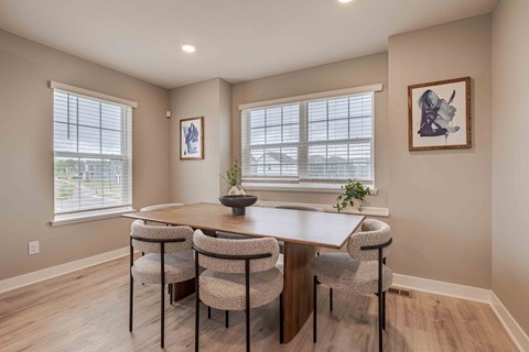 a dining room with a table and chairs