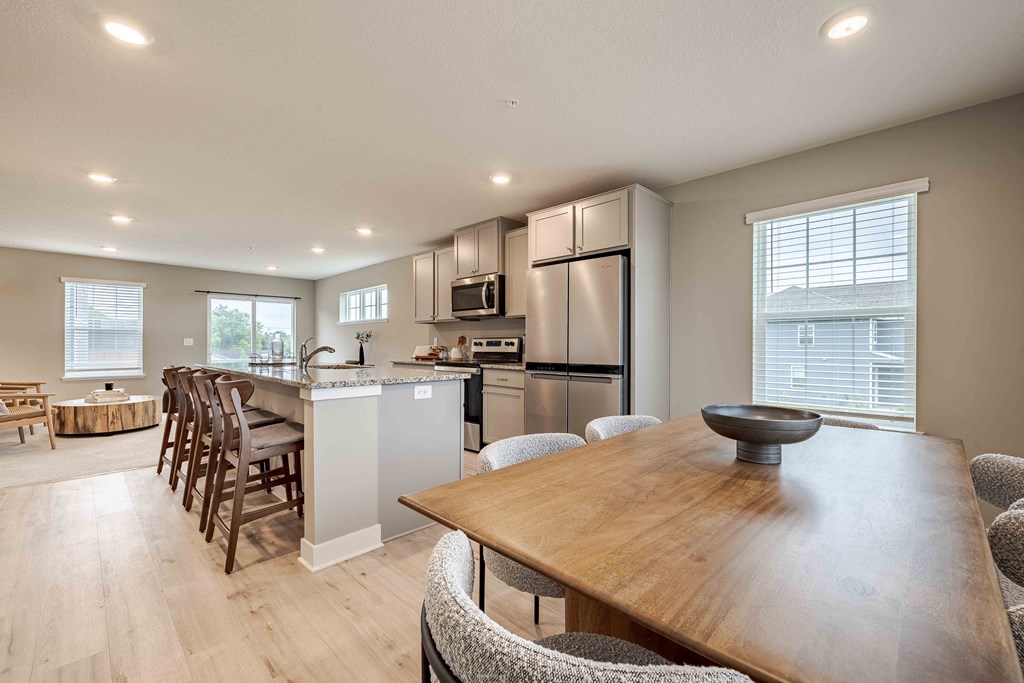a kitchen and dining room with a table and chairs