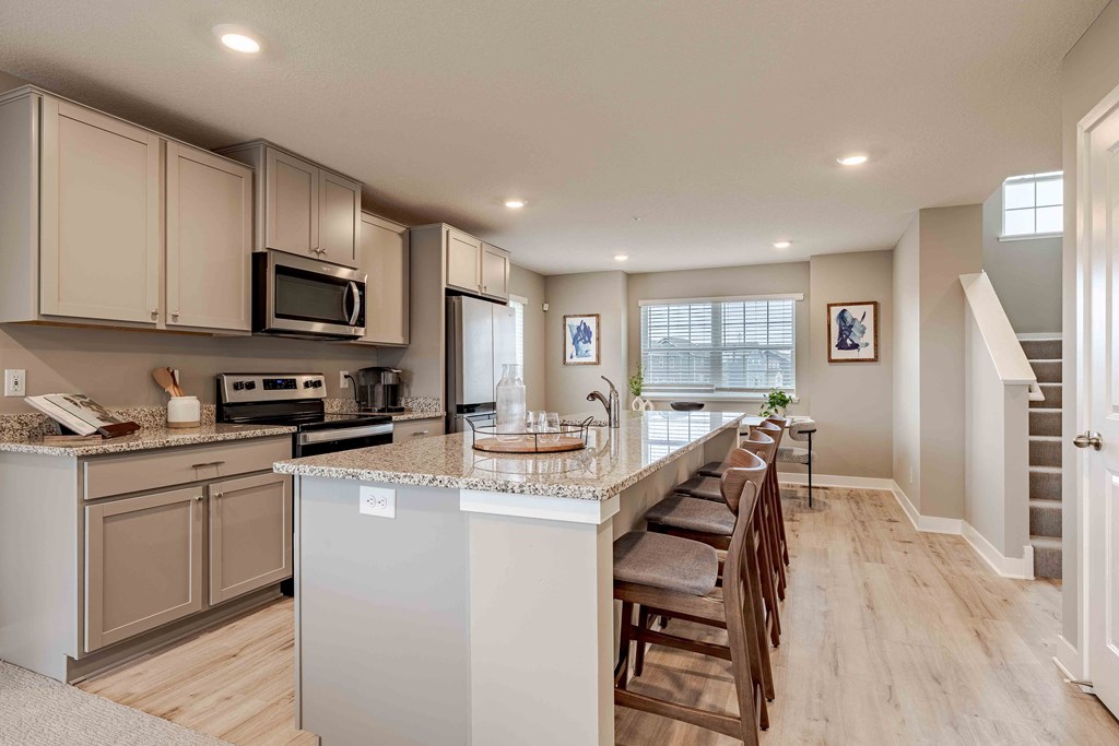 a kitchen with an island and a table with chairs