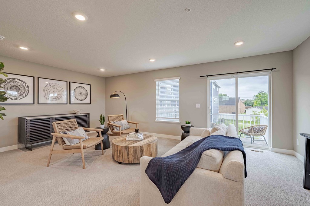 a living room with a couch and chairs and a television