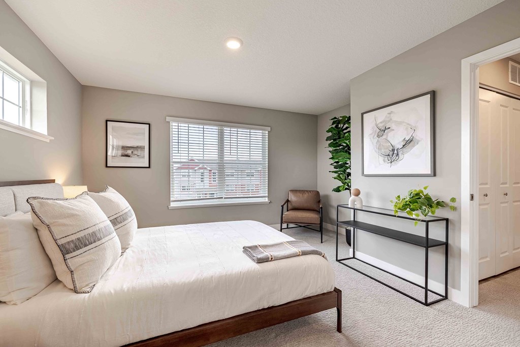 a bedroom with a large bed and a window