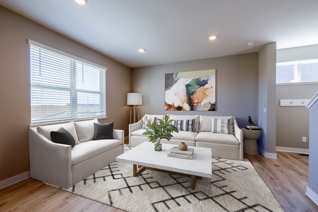 a living room with white couches and a coffee table
