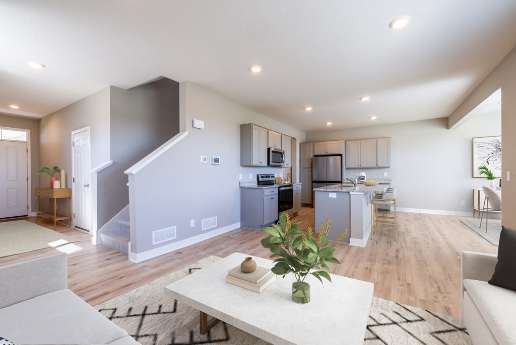 a living room and kitchen with a couch and a table