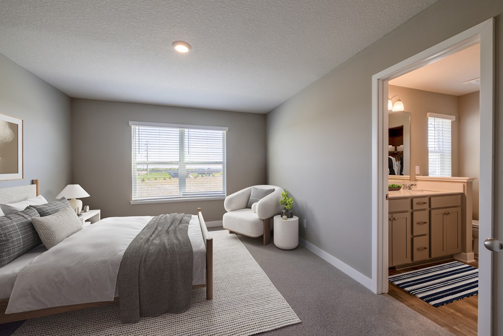 a bedroom with a bed and a chair and a mirror