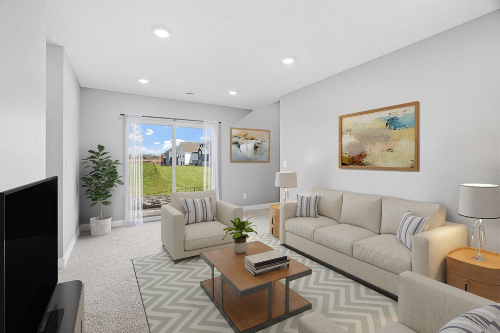 A living room with a couch, chair, and television.