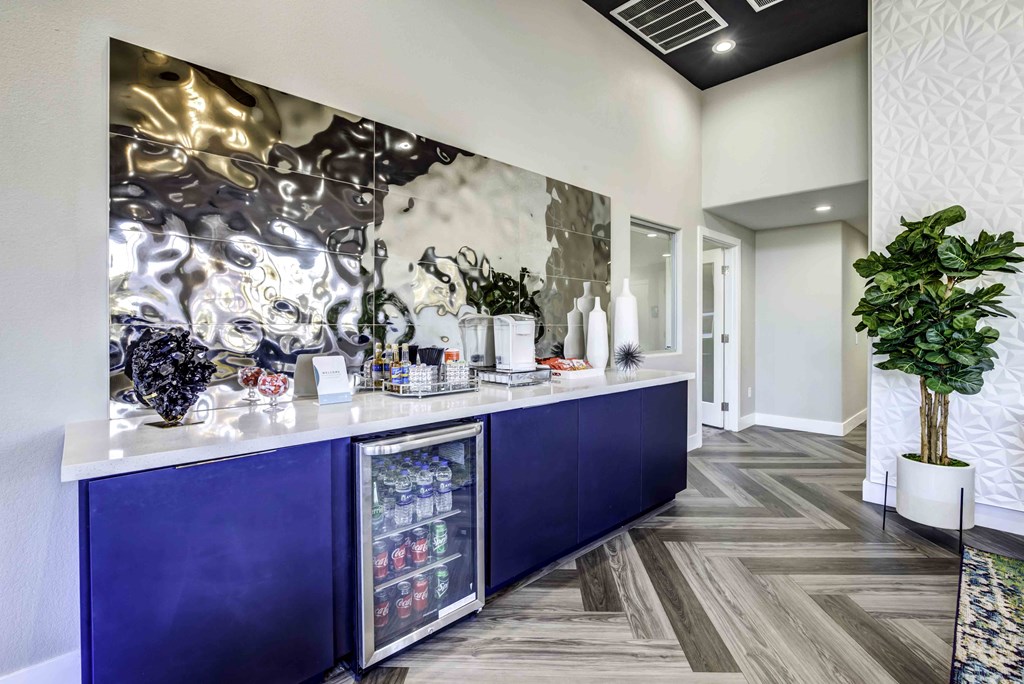 a kitchen with a counter and a plant in a lobby