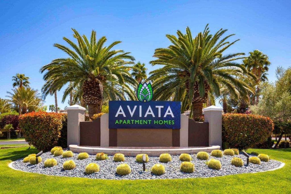 the sign for avataa apartments homes in front of palm trees