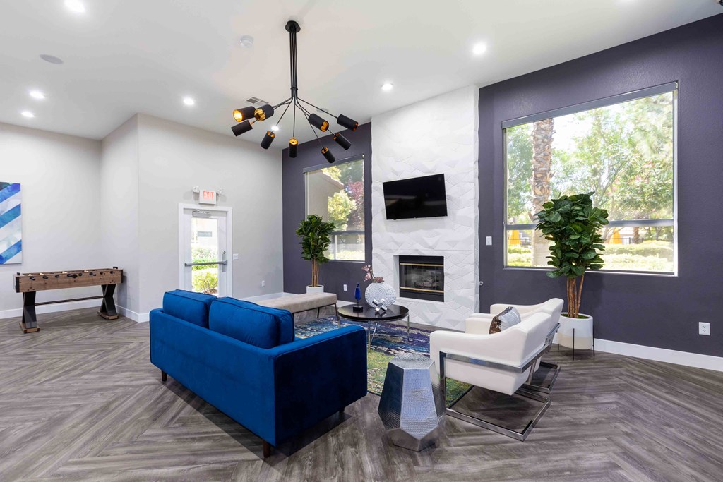 a living room with a blue couch and a fireplace