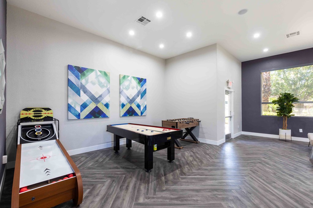 game room with two foosball tables and a pool table