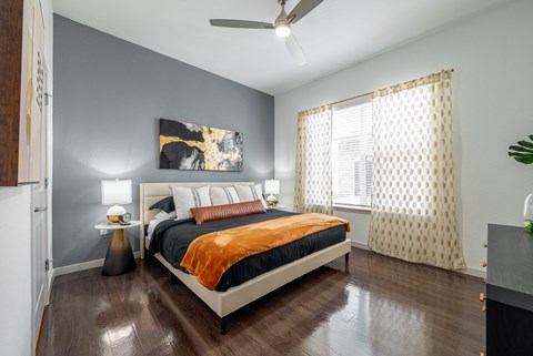 a bedroom with a bed and a ceiling fan