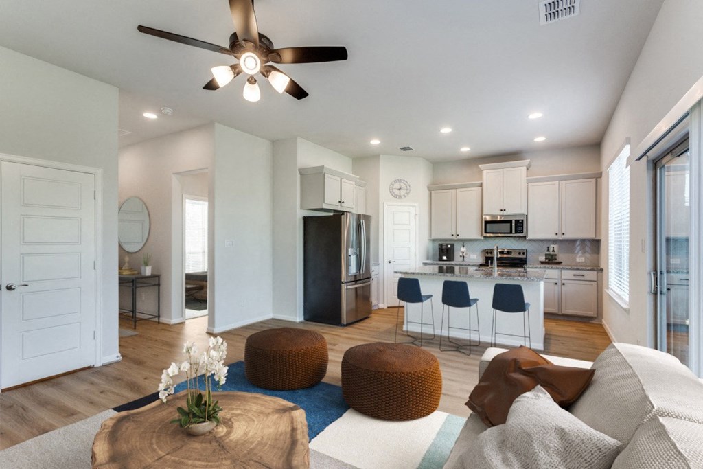 A modern living room with a white couch and a wooden coffee table.