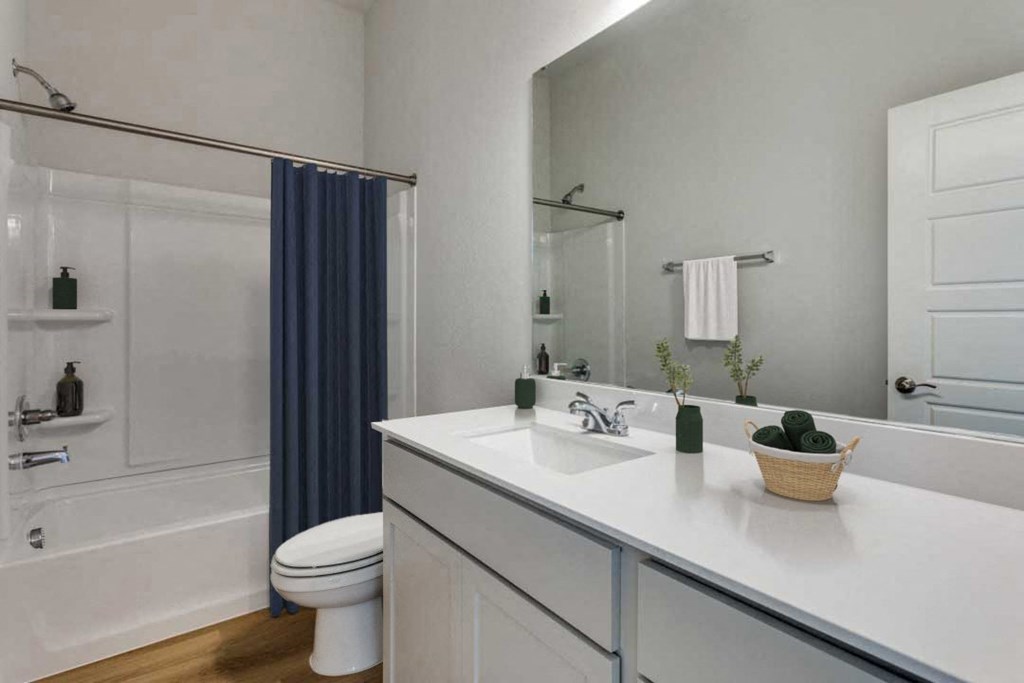 A white bathroom with a white toilet and a white sink.