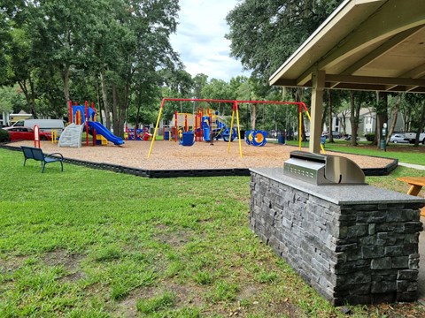 Chelsea Apartments in Gainesville Florida photo of playground and grill area