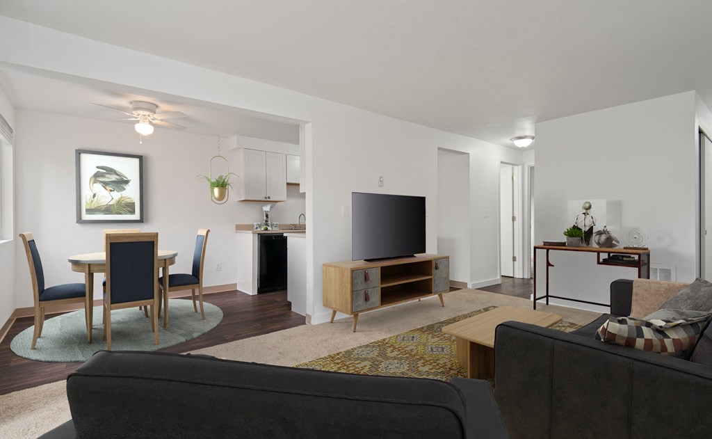 a living room with a couch and a table with a television