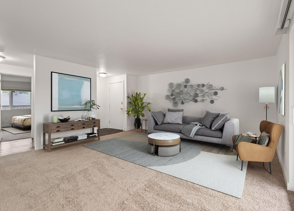 a living room with a gray couch and a rug