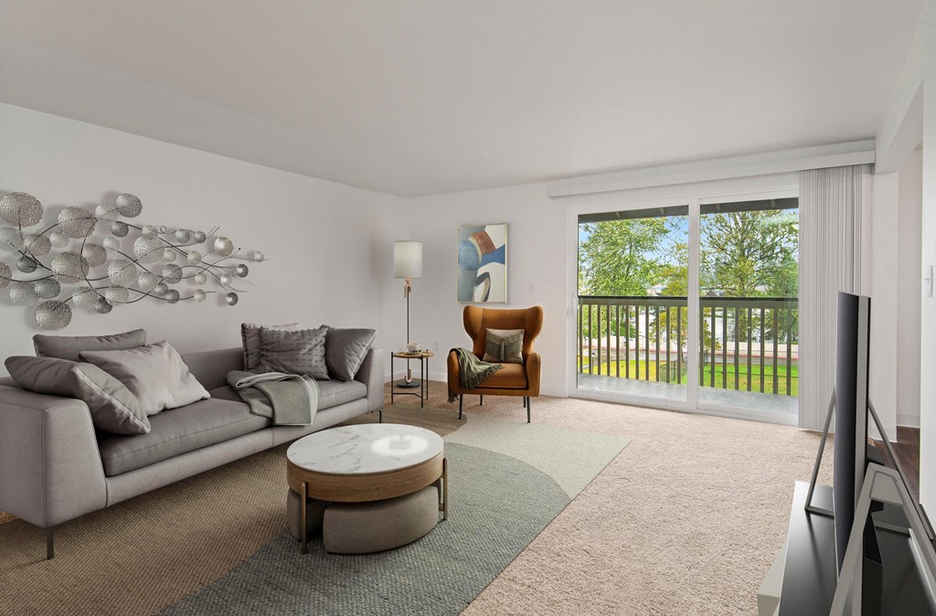 a living room with a couch and a chair and a sliding glass door