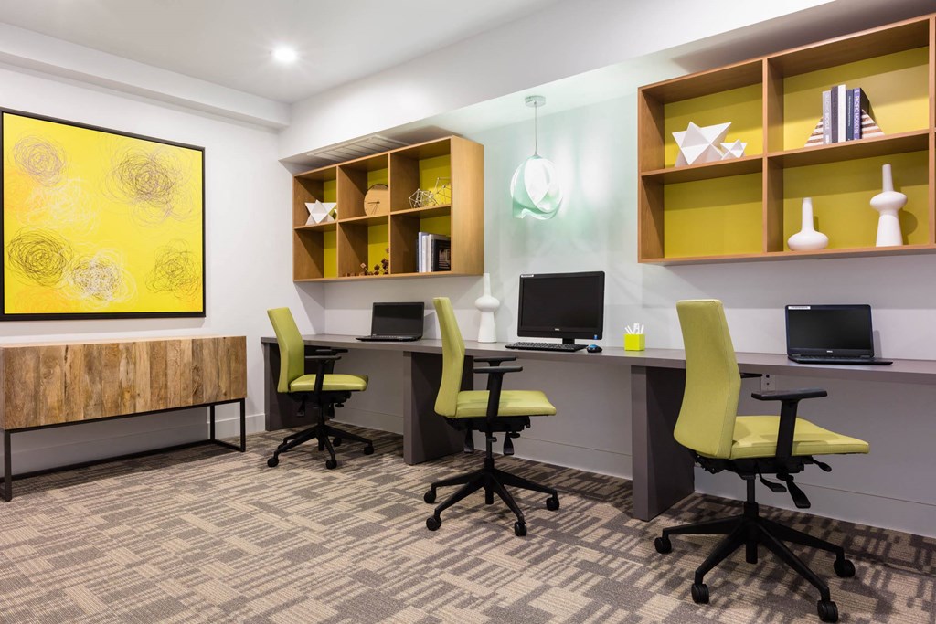 a room with two desks with computers and chairs