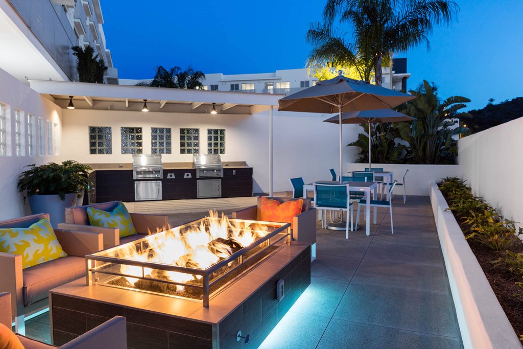a patio with a fire pit at night