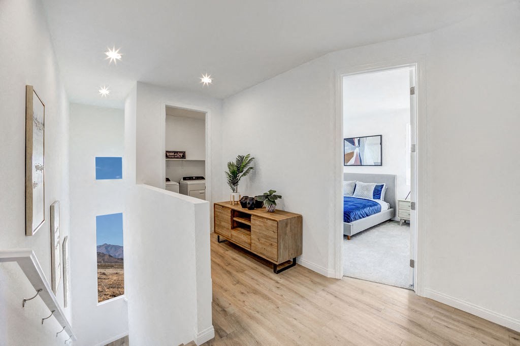 a living room with a bed and a wooden floor