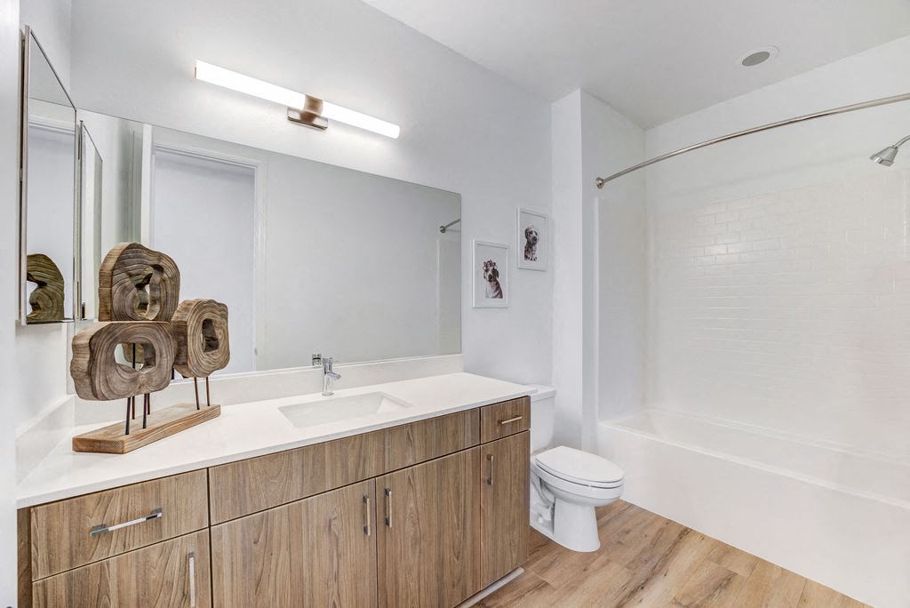 a bathroom with a toilet sink and a mirror