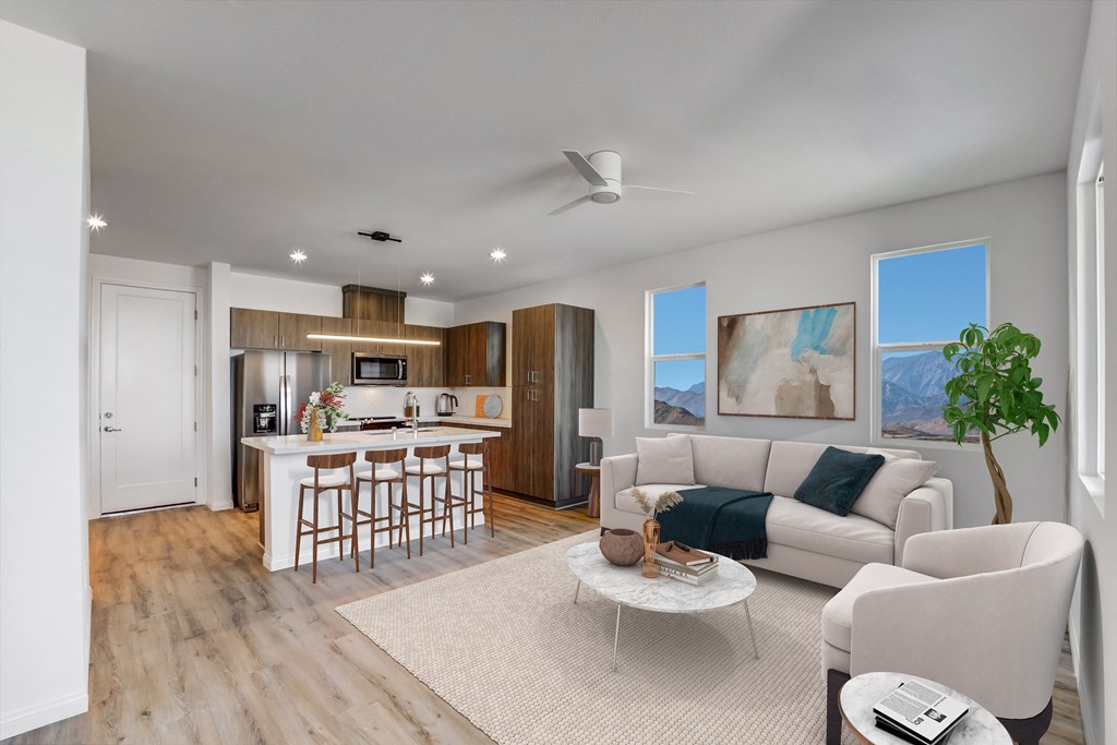 a living room with a kitchen and a couch and a table