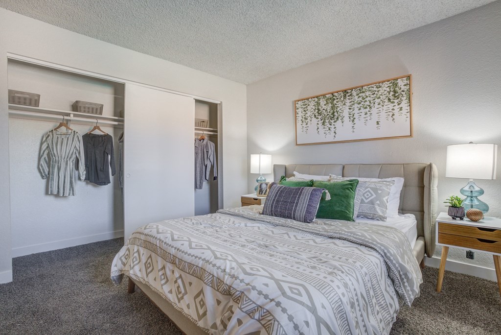 One-Bedroom Apartments in North Mountain Village, Phoenix, AZ - Ardella on 28th - Furnished Bedroom with Carpet Flooring and a Large Closet with Storage Shelf