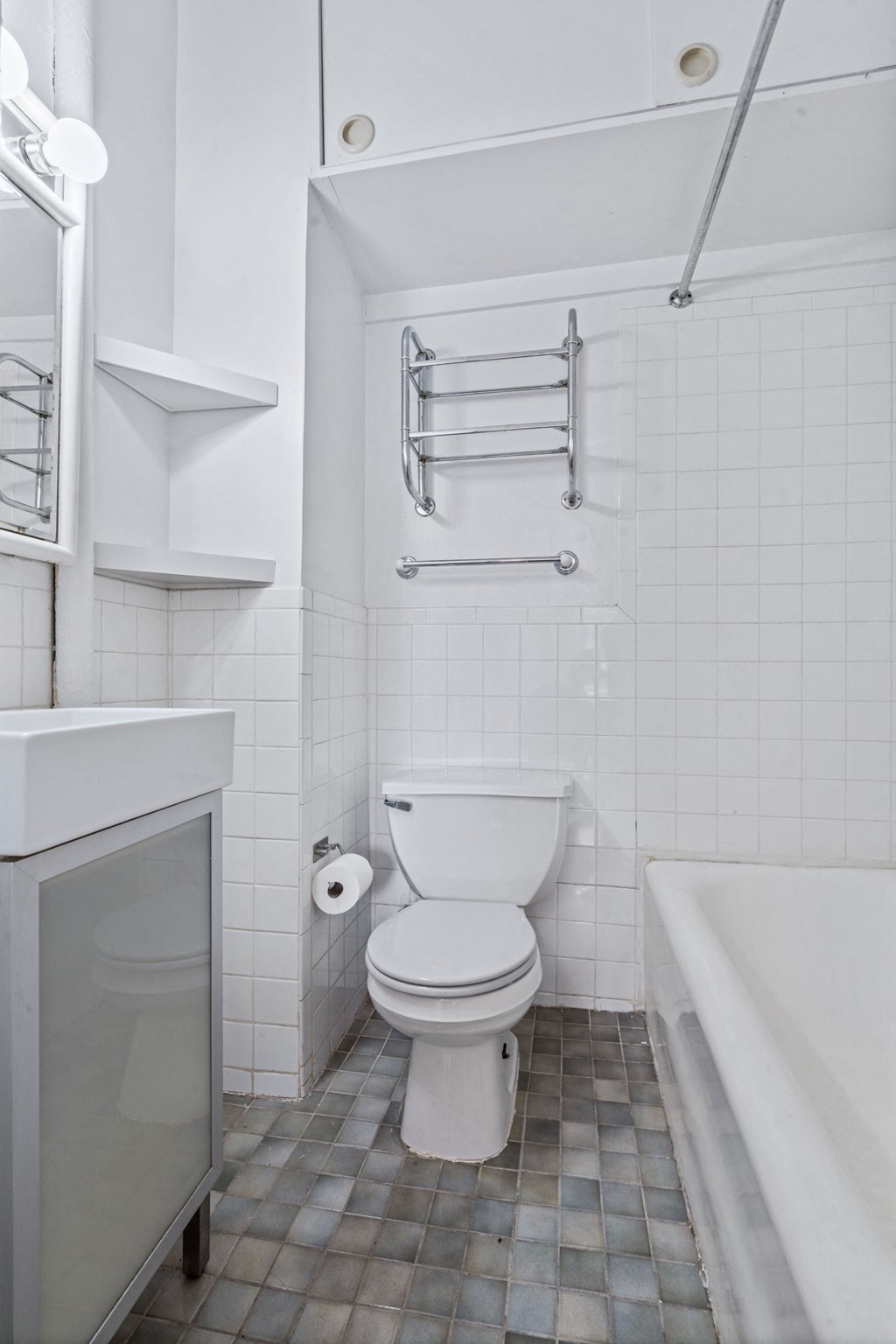 a white bathroom with a toilet and a tub
