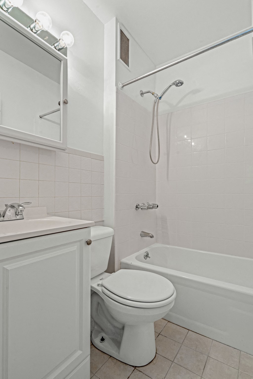 a bathroom with a toilet and a tub and a sink