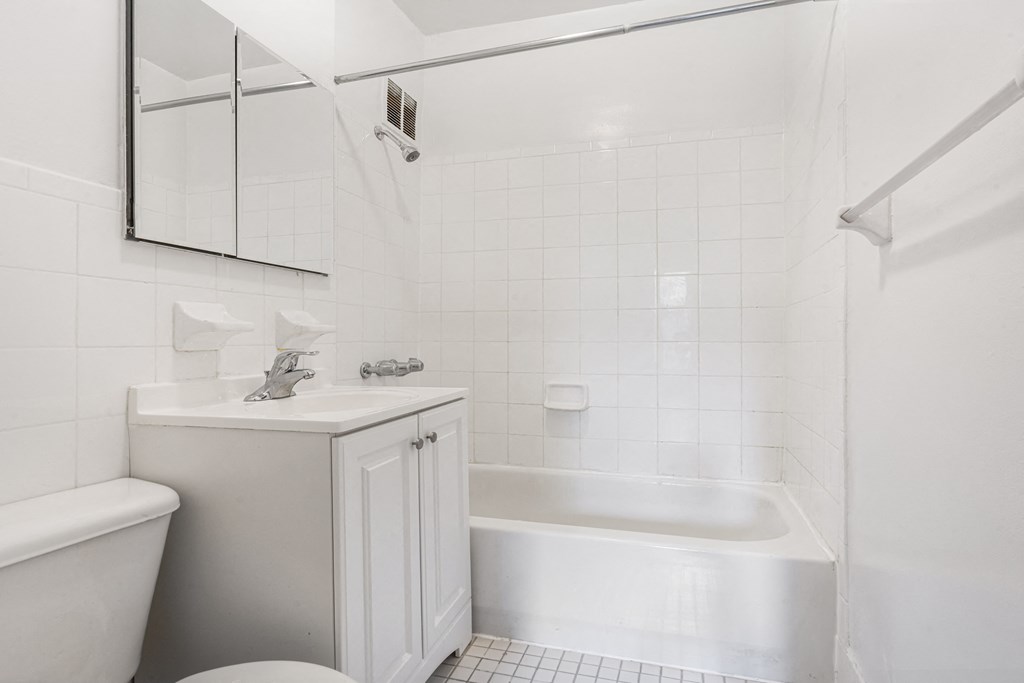 a white bathroom with a sink and a toilet