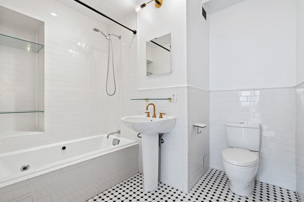 a white bathroom with a sink toilet and tub