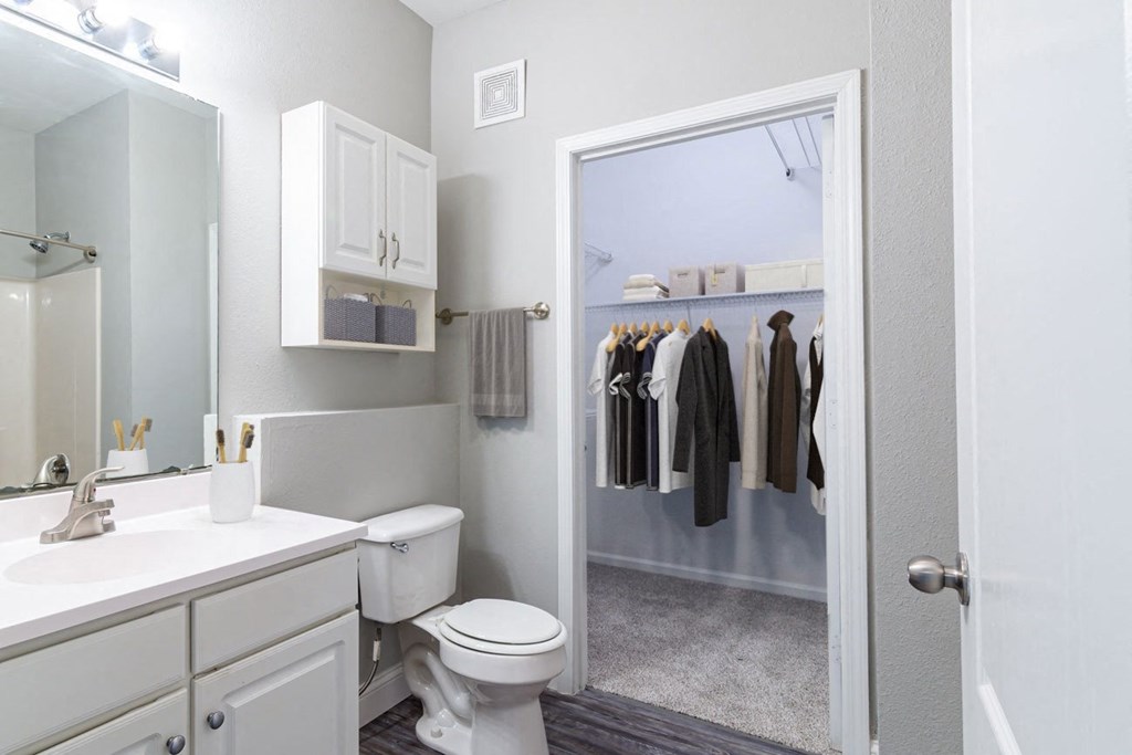 a bathroom with a toilet and a mirror