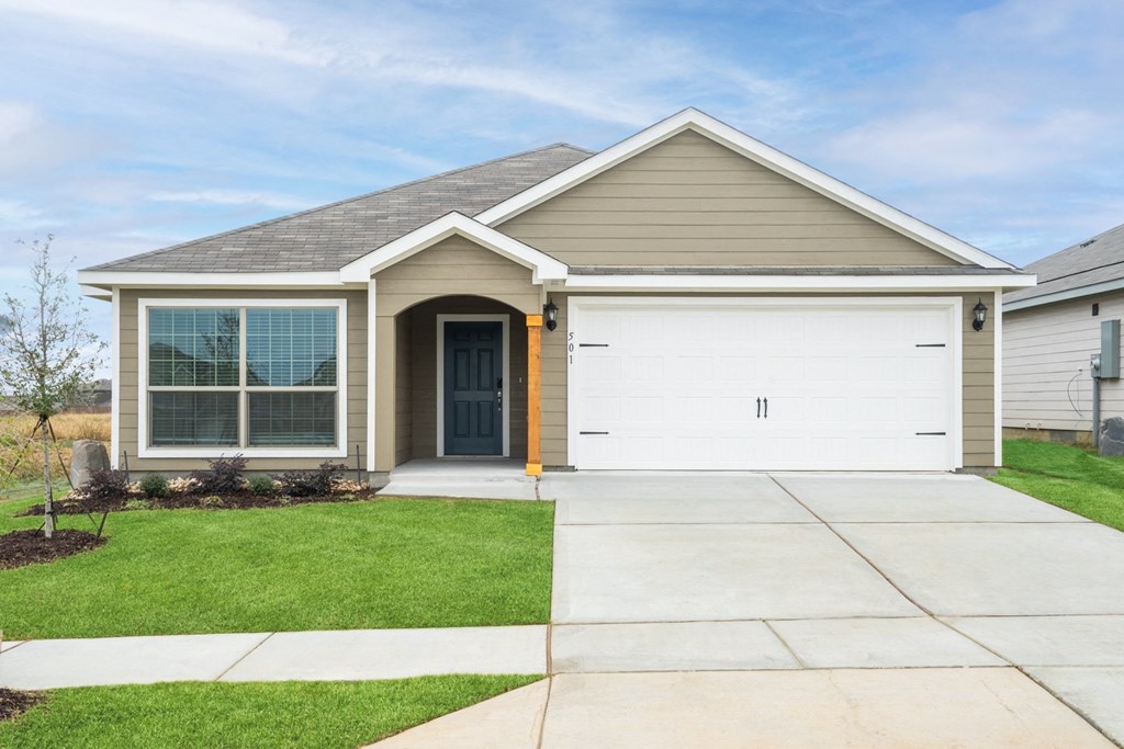 a house with a white garage door and a sidewalk in front of it