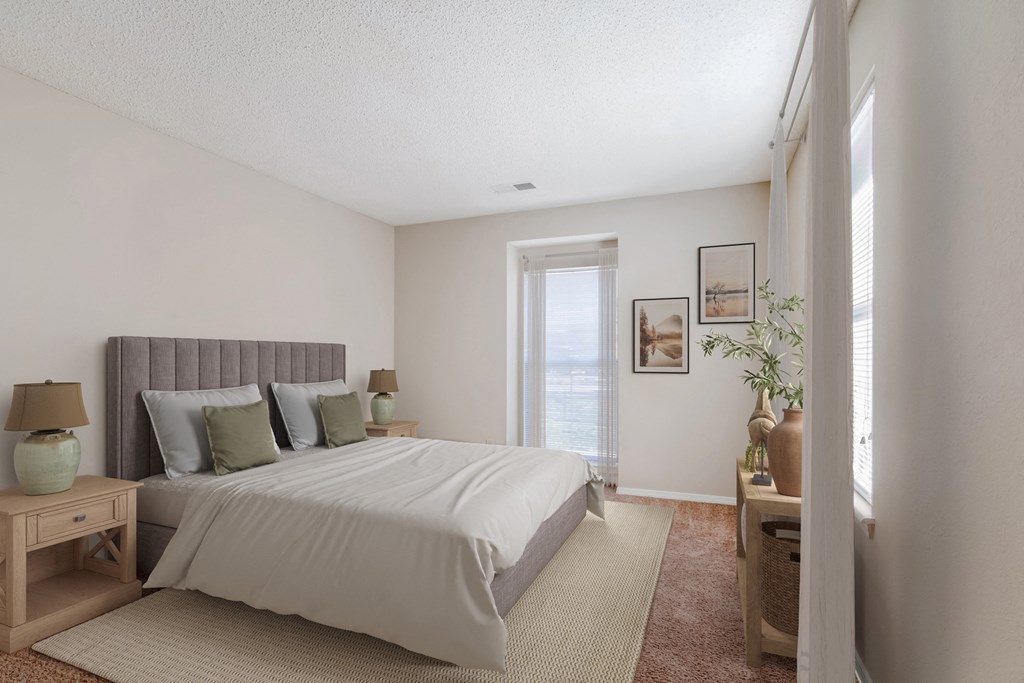 a bedroom with a large bed and a window