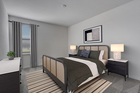 A bedroom with a bed, nightstand, and a plant.