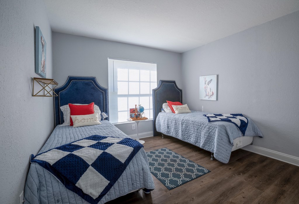 Comfortable bedroom with expansive windows at Belara Lakes apartments in Tampa, FL near Egypt Lake and Lowry Park