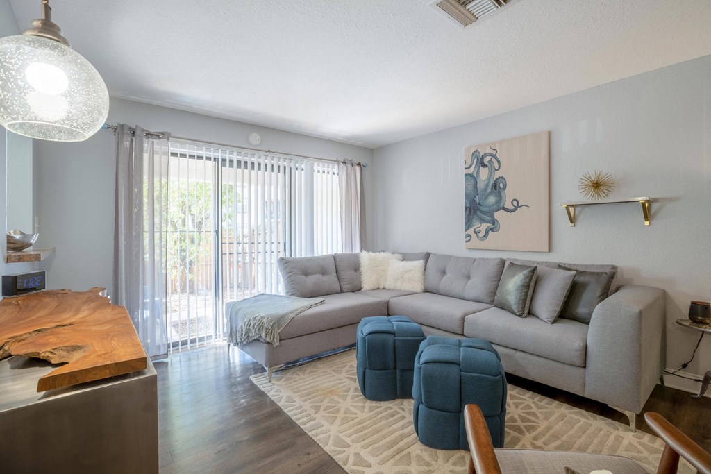 Bright living room with sliding glass doors at Belara Lakes apartments near Egypt Lake / Lowry Park in Tampa, Florida