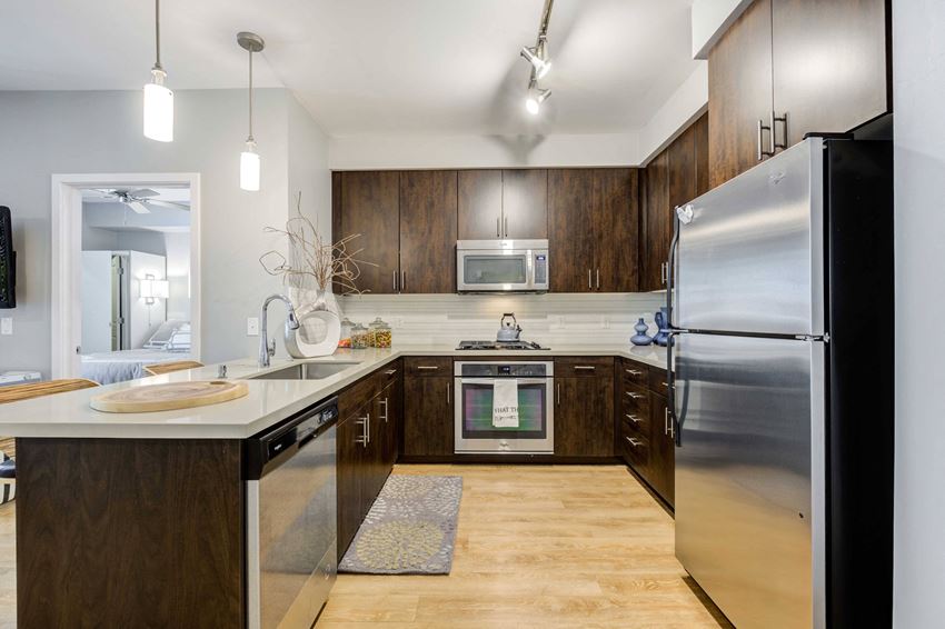 a kitchen with stainless steel appliances and wooden cabinets