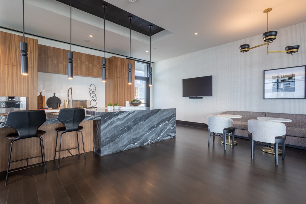 a kitchen with a marble counter top and a dining room with a table and chairs