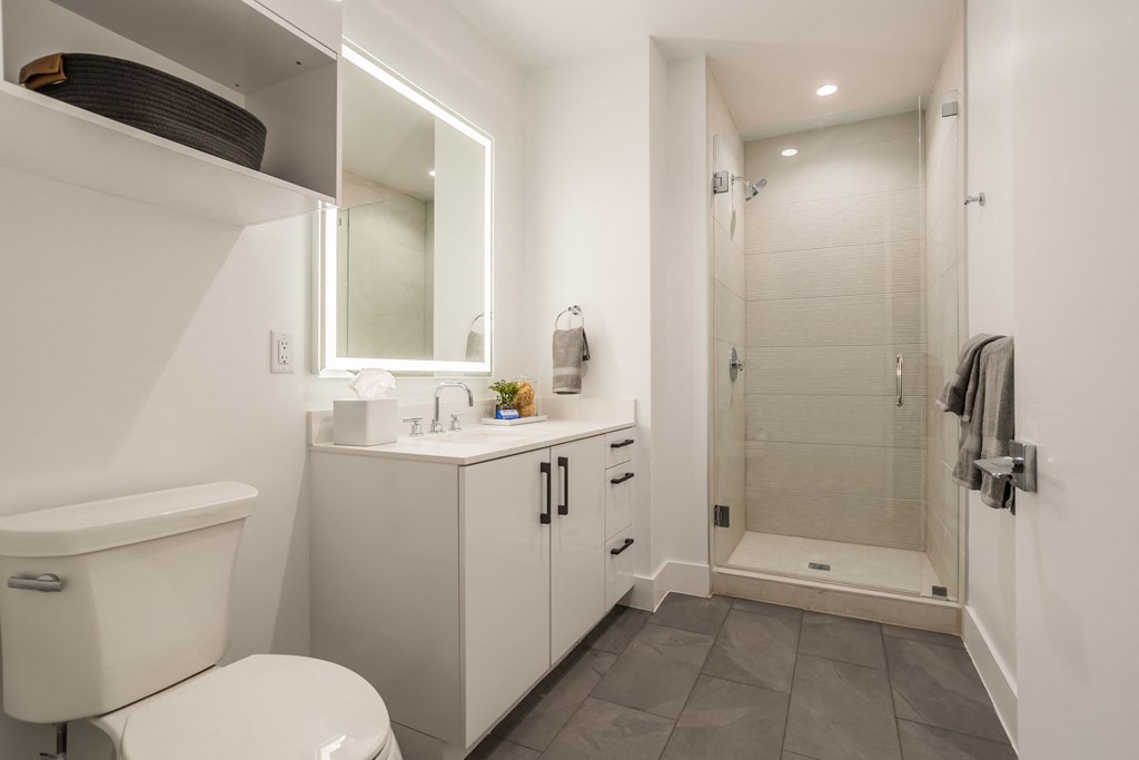 a bathroom with a toilet sink and a shower