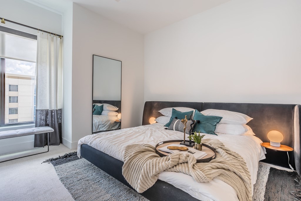 a bedroom with a large bed and a large window