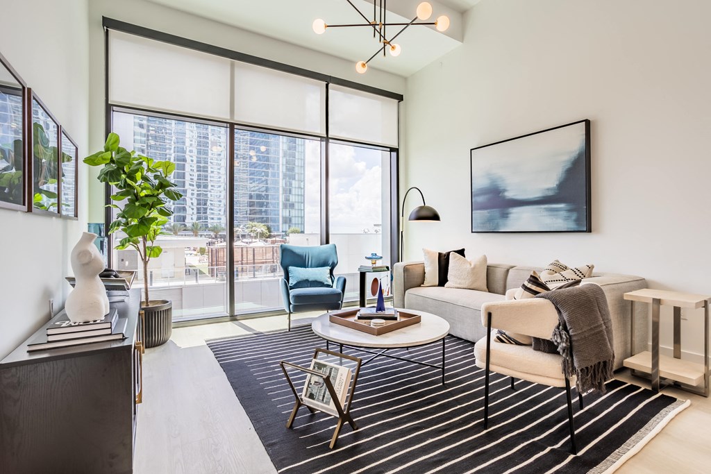 a living room with a white couch and a large window