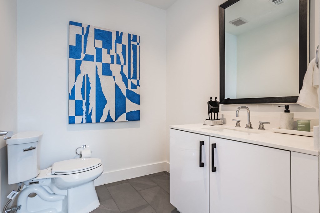 a bathroom with a toilet and a sink and a mirror